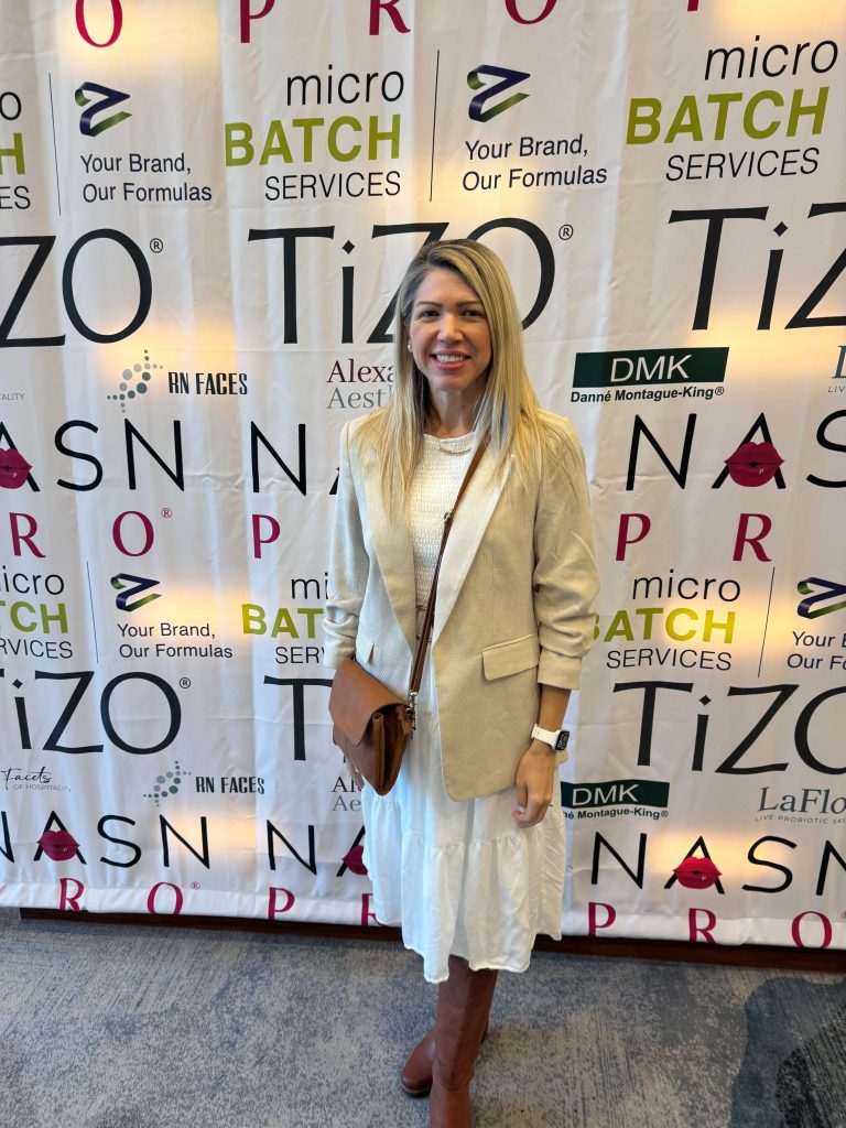 Heidi Faust at an esthetics industry conference with skincare professionals.
